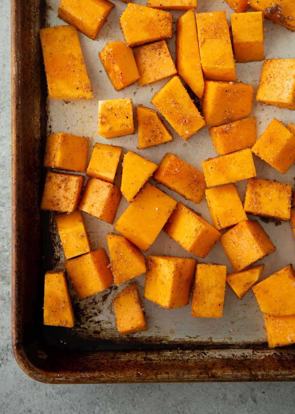 roasted butternut squash cubes on a sheet pan