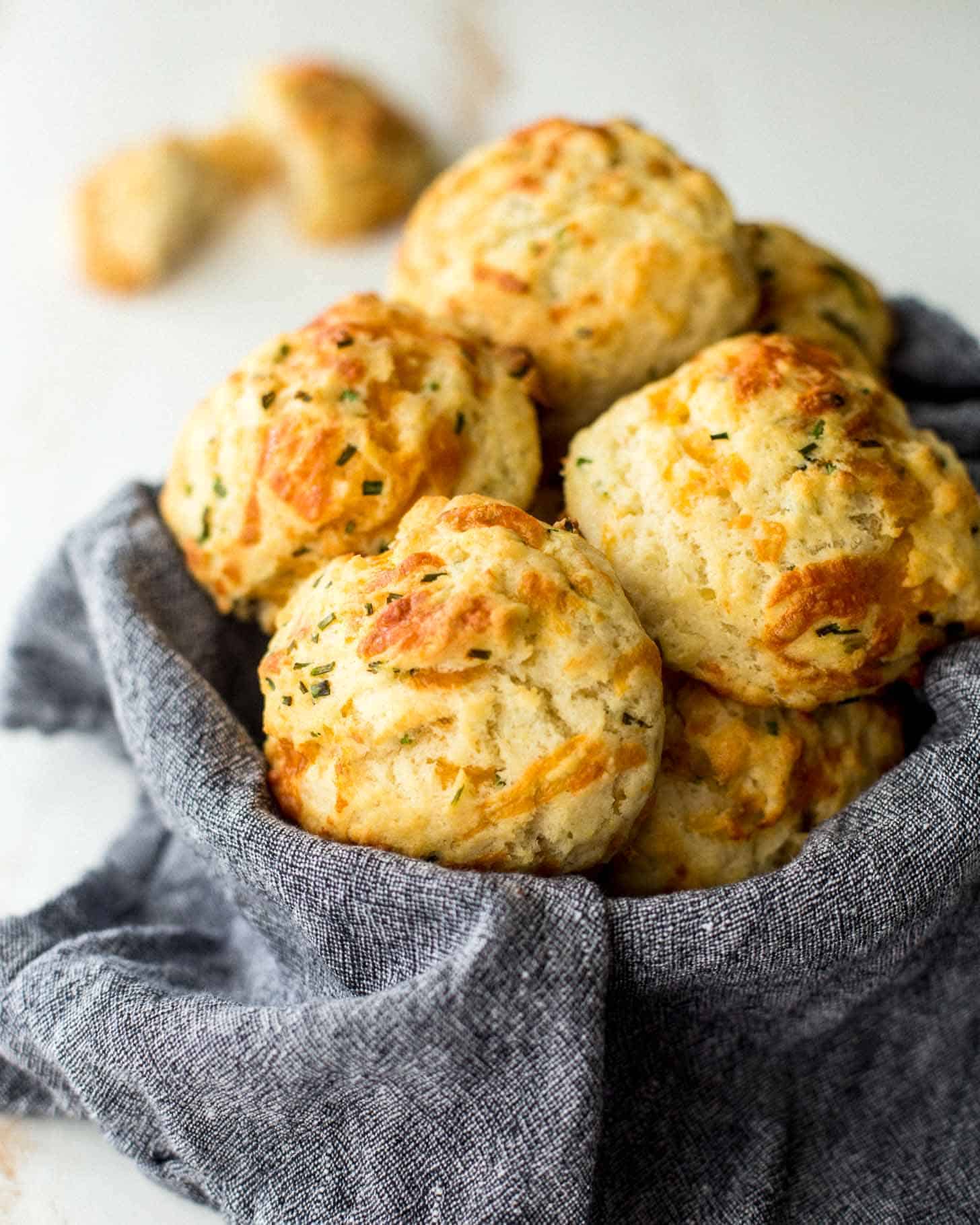 cheddar drop biscuits in a towel lined basket