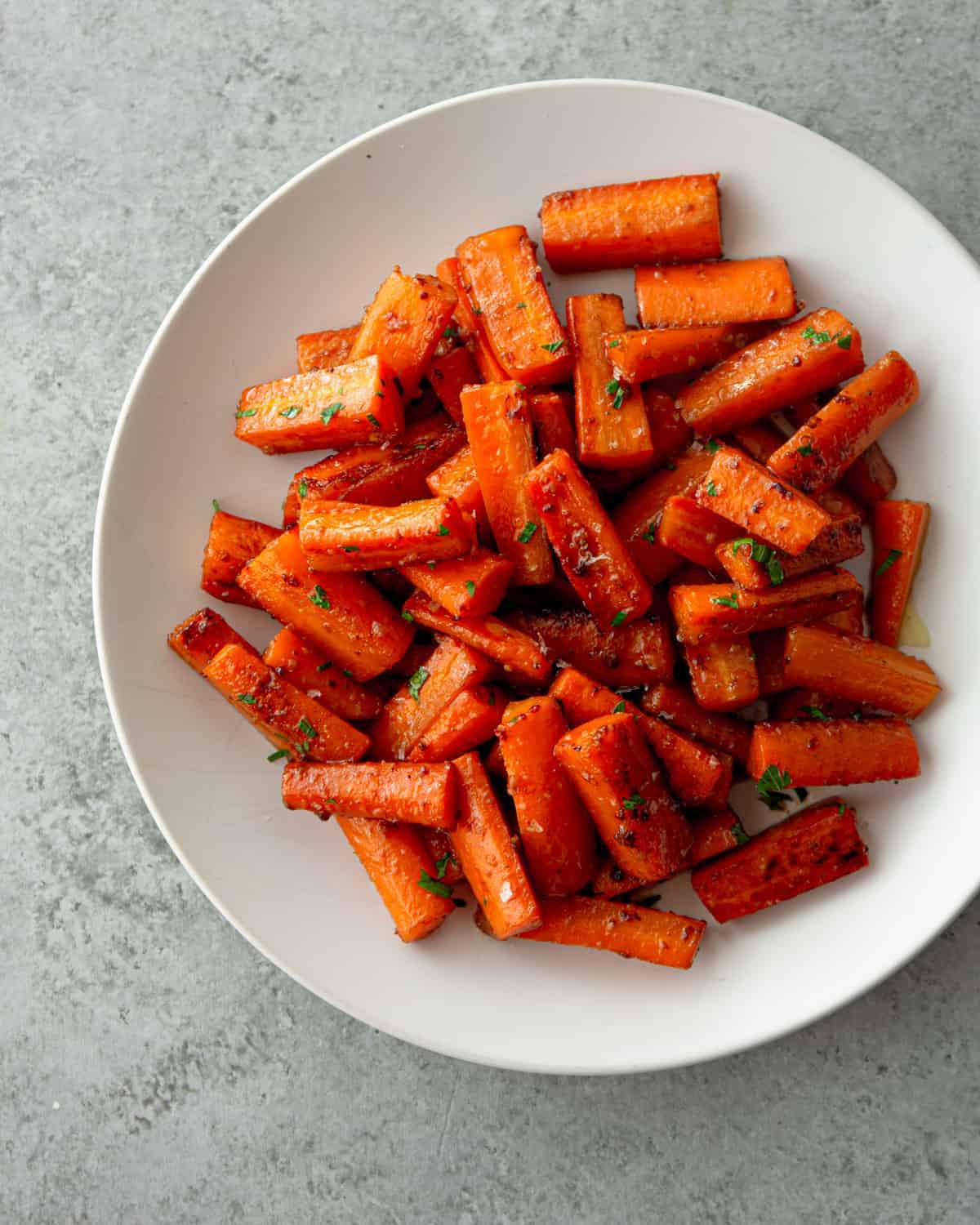 glazed carrots in a white bowl