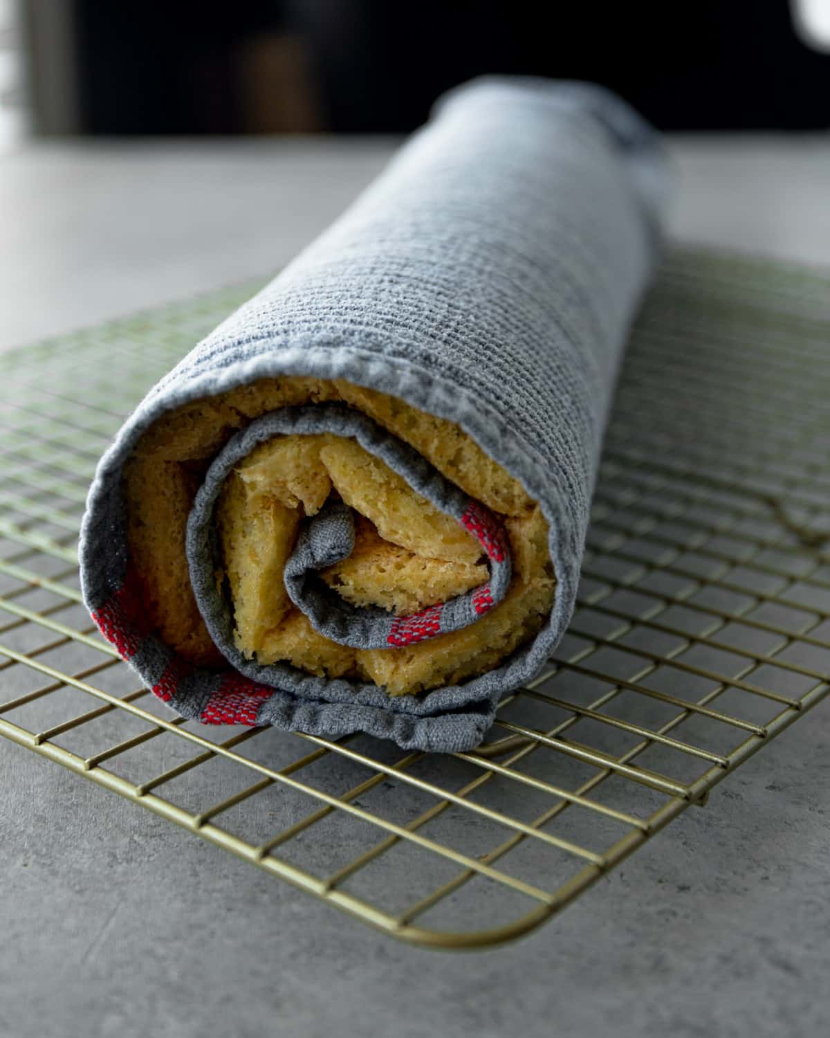 a baked cake rolled up in a dish towel