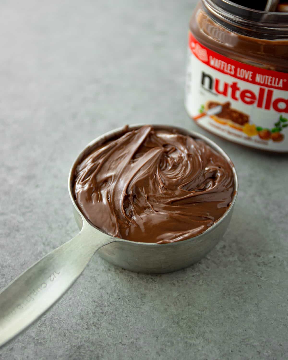 a measuring cup of nutella