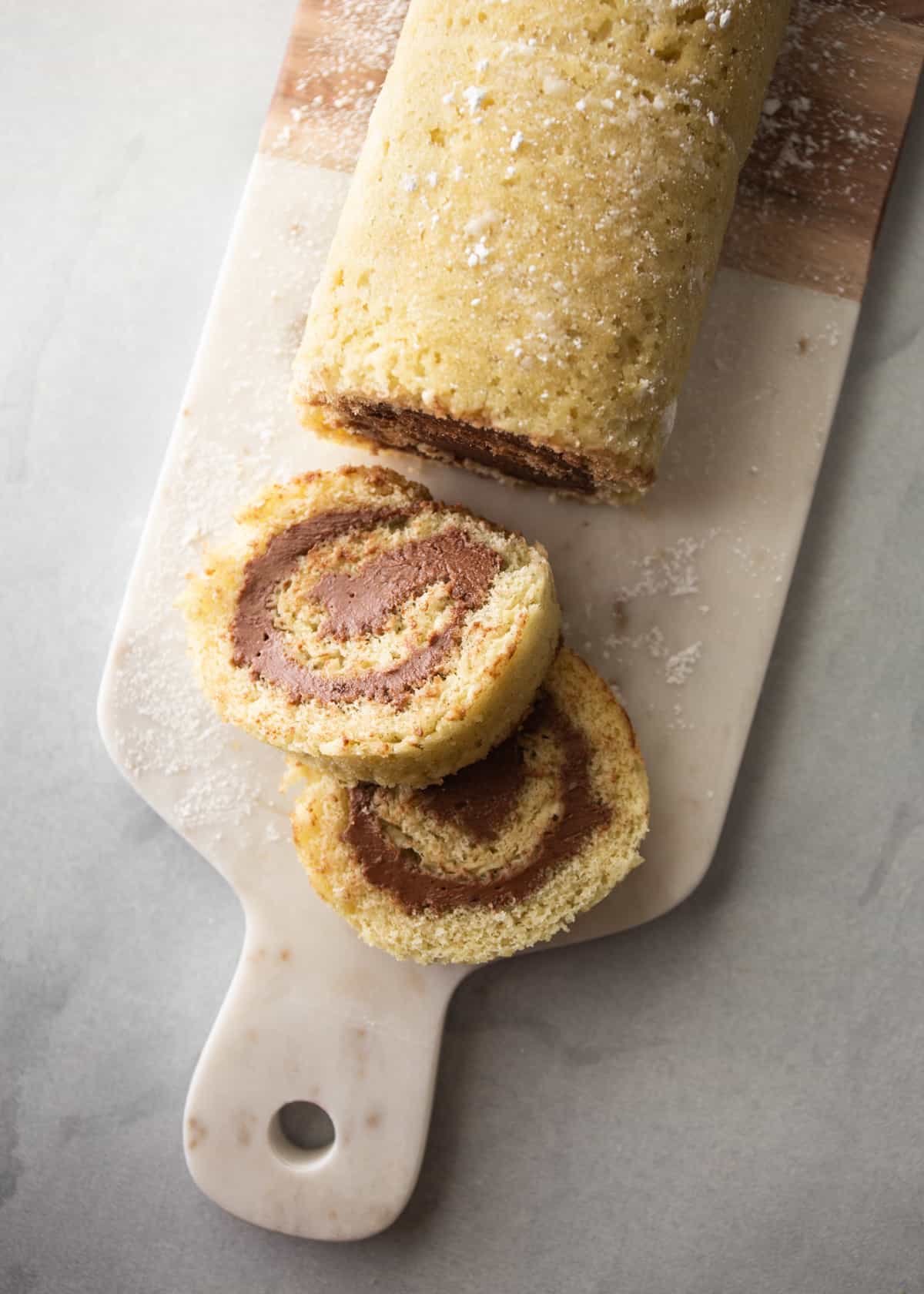 overhead image of cake roll on a wooden board