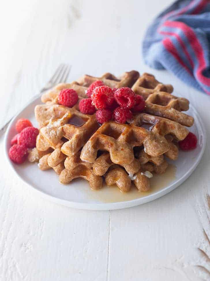 a stack of waffles on a white table