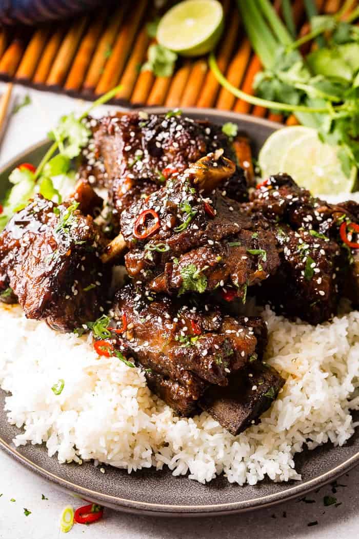short ribs over rice on a grey plate