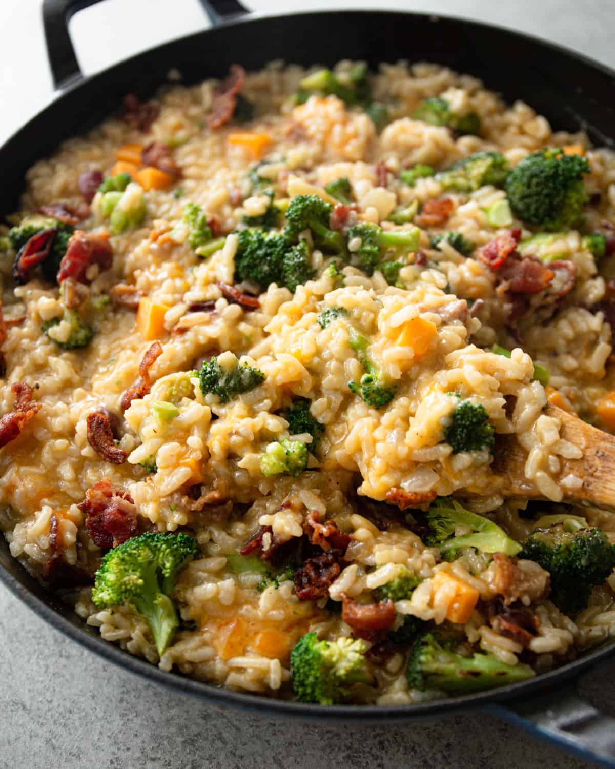 broccoli and cheddar risotto in a cast iron skillet