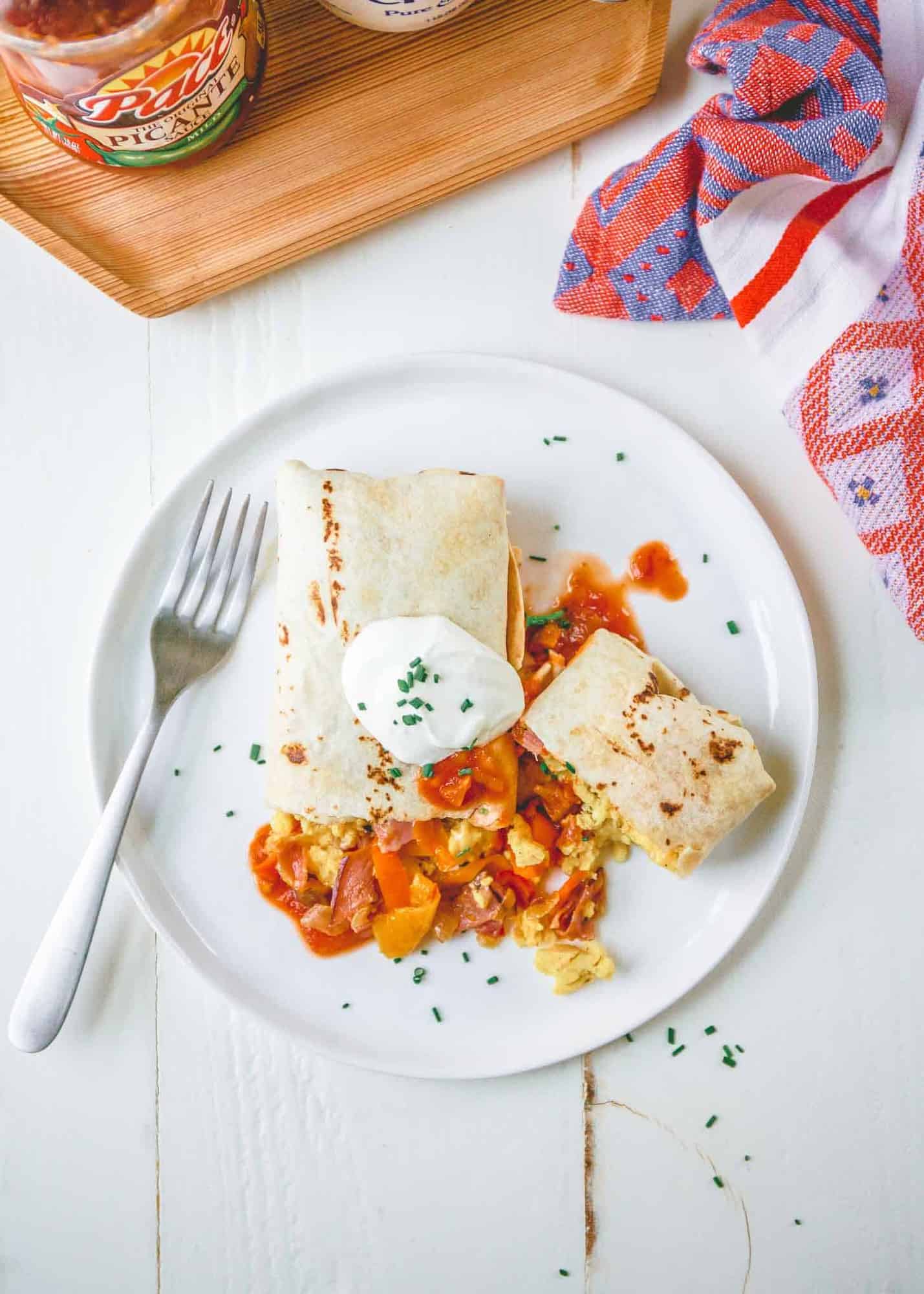 a breakfast burrito on a white plate