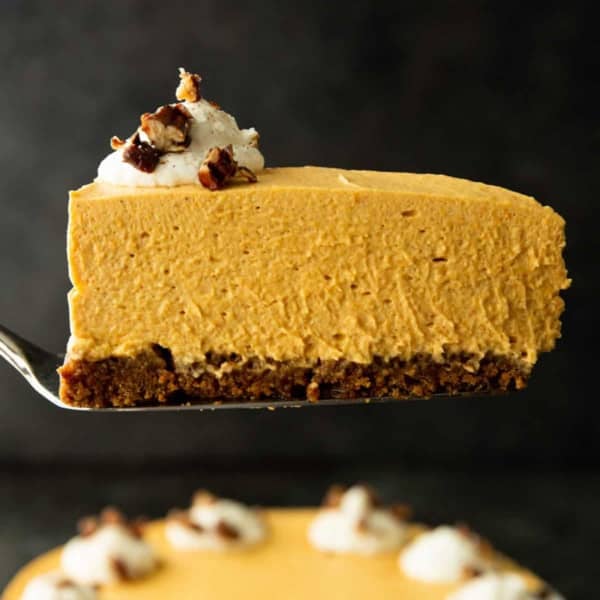 a slice of pumpkin cheesecake with gingersnap crust