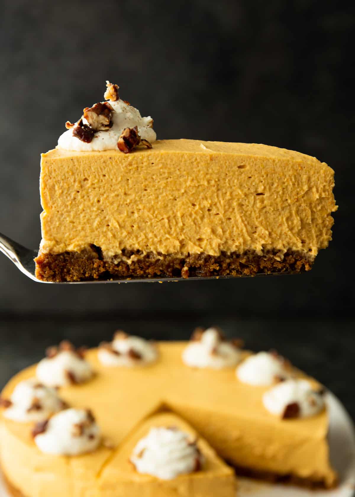 a slice of pumpkin cheesecake on a pie server