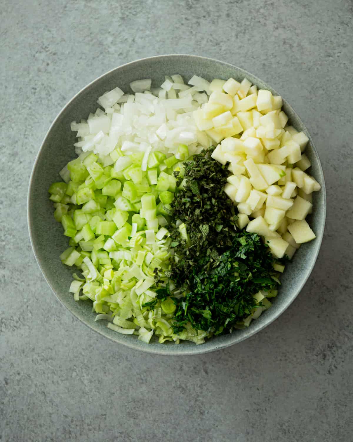 uncooked vegetables, diced and in a grey bowl