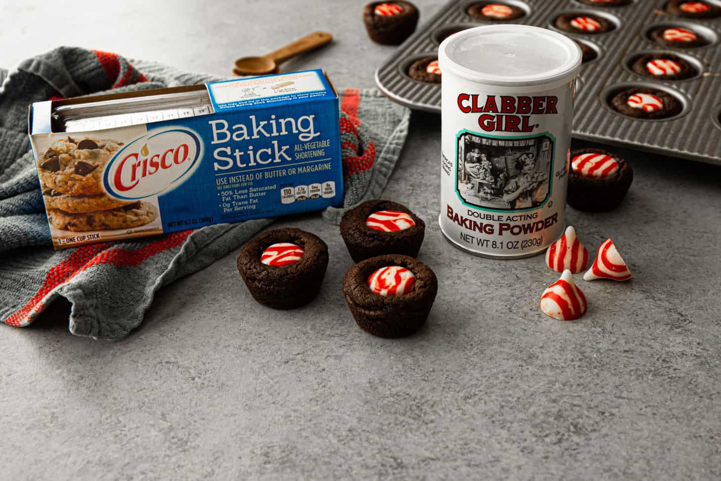 brownie bites with crisco and baking powder on a grey countertop