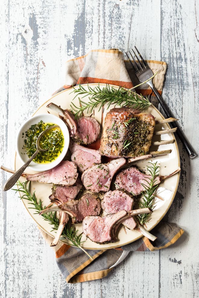 sliced rack of lamb on a white plate