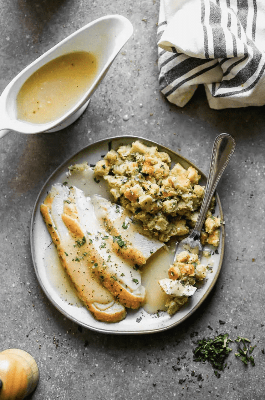 turkey, gravy and stuffing on a white plate