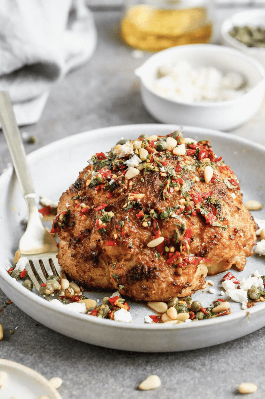 whole roasted cauliflower in a white bowl