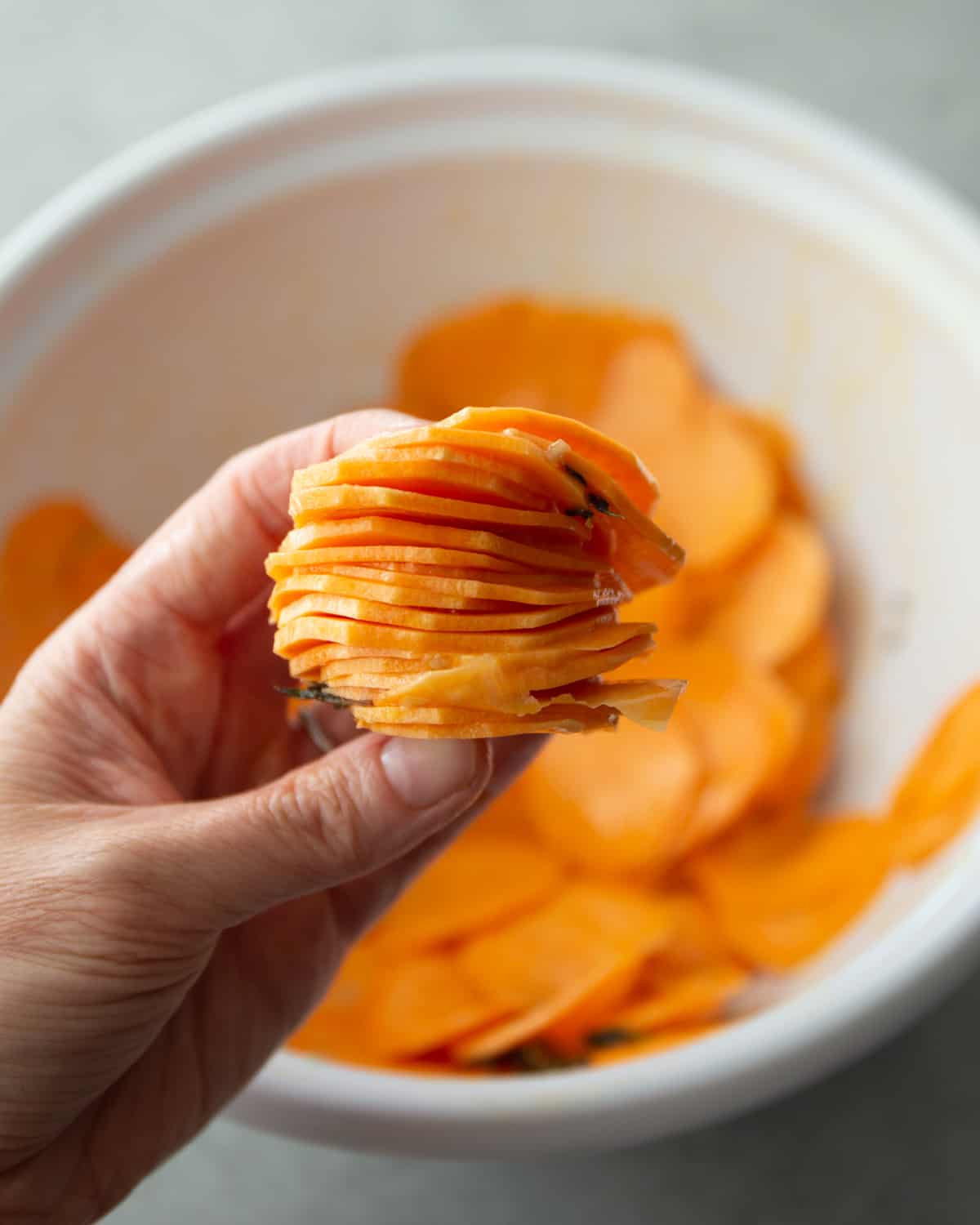 stacking sliced sweet potatoes