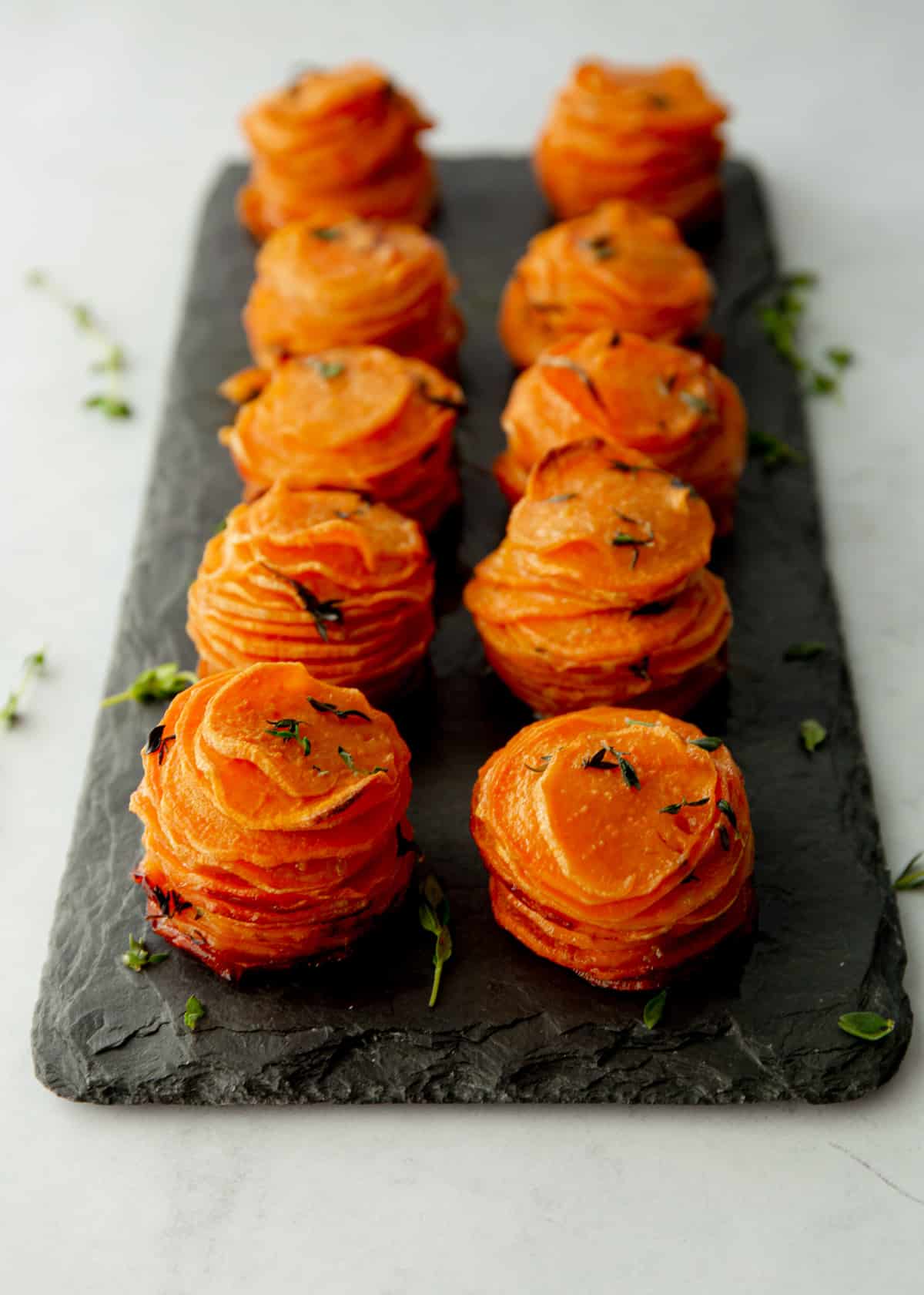 sweet potato stacks on a grey tray