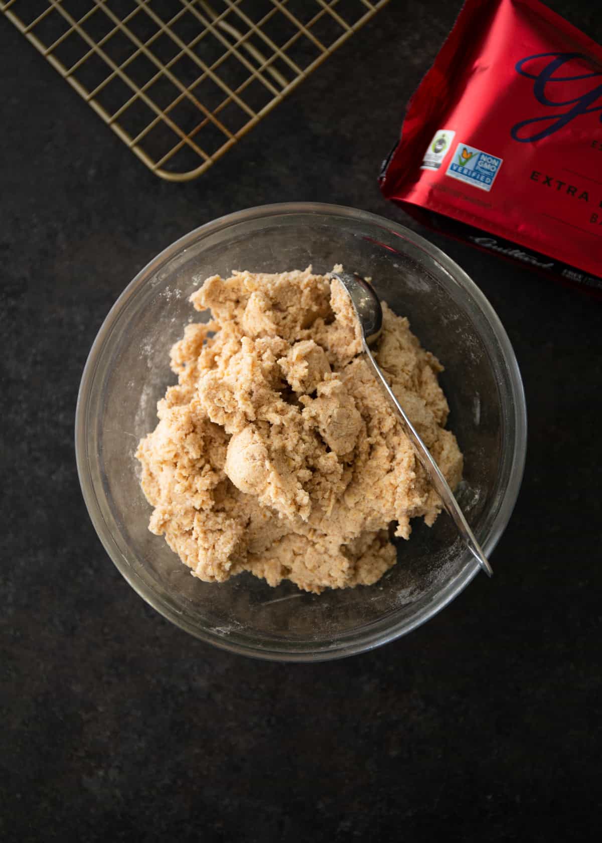 cookie batter in a clear glass mixing bowl