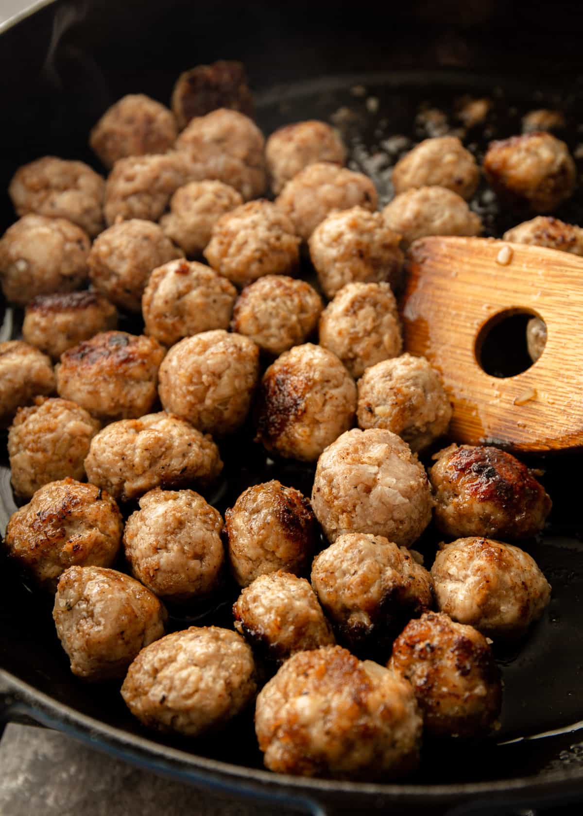 browning meatballs in a cast iron skillet