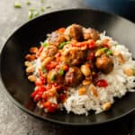 meatballs and rice in a black bowl