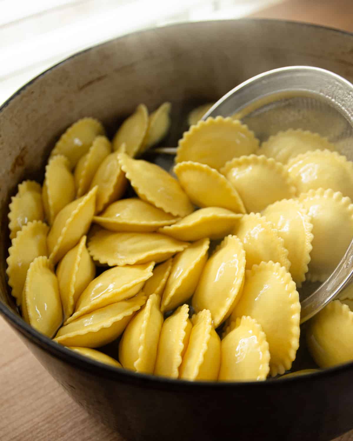 boiling ravioli in a sauce pan