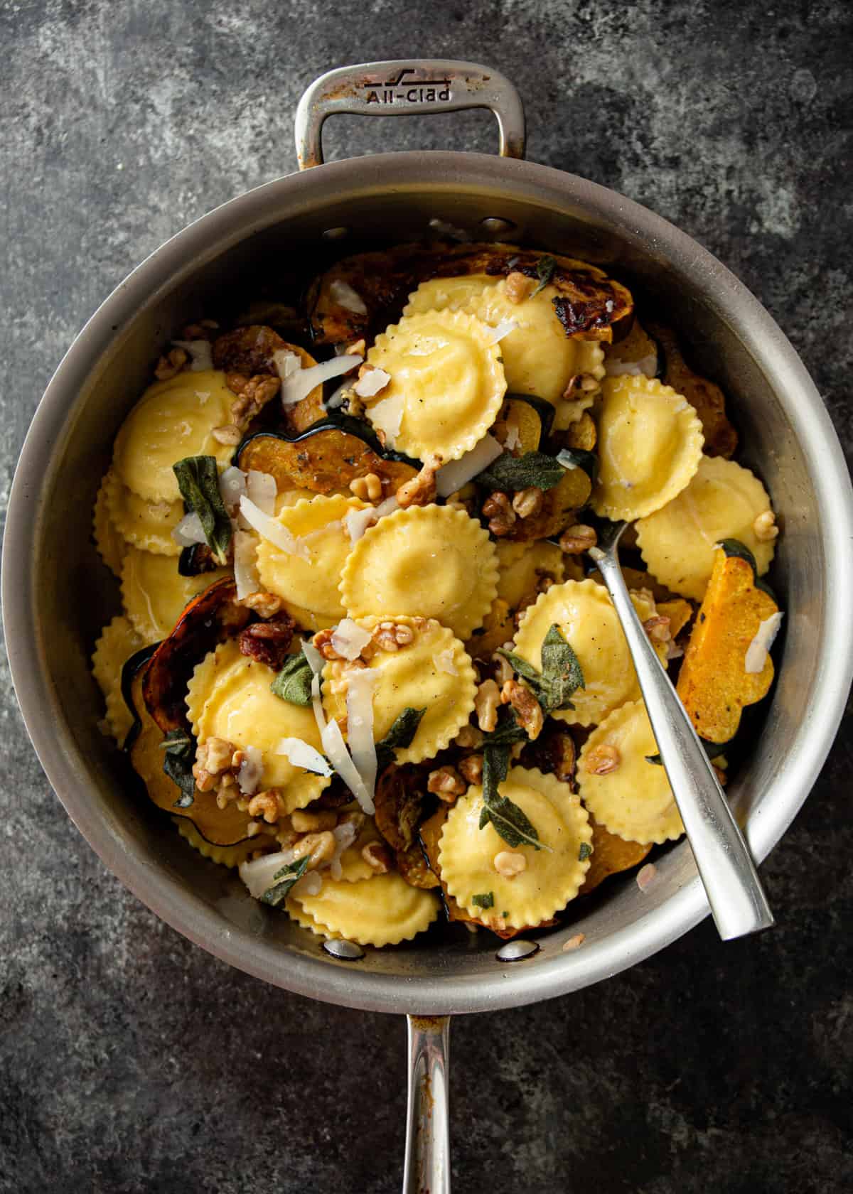 stirring ravioli and squash into brown butter sauce