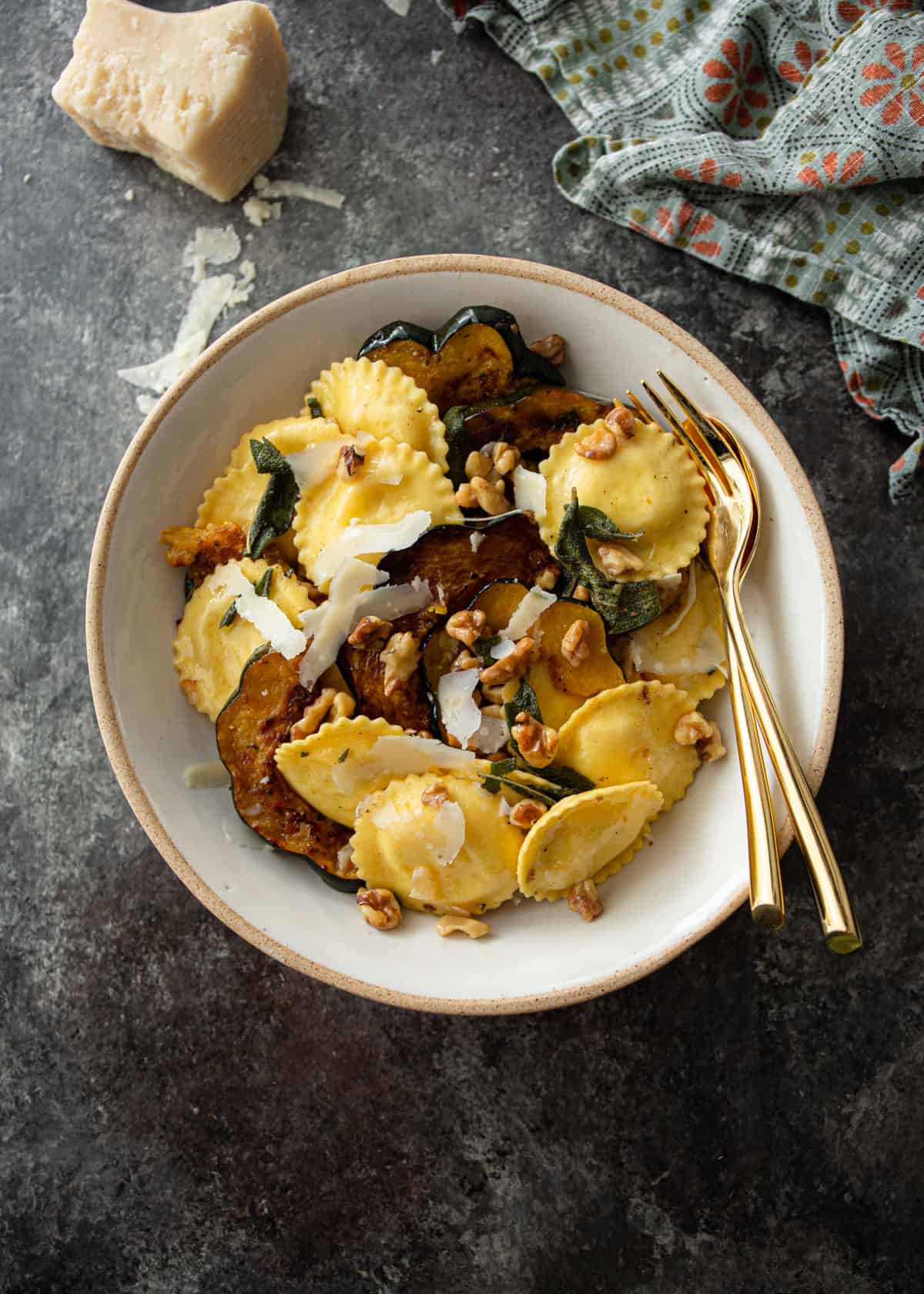 overhead image of brown butter ravioli in a white bowl