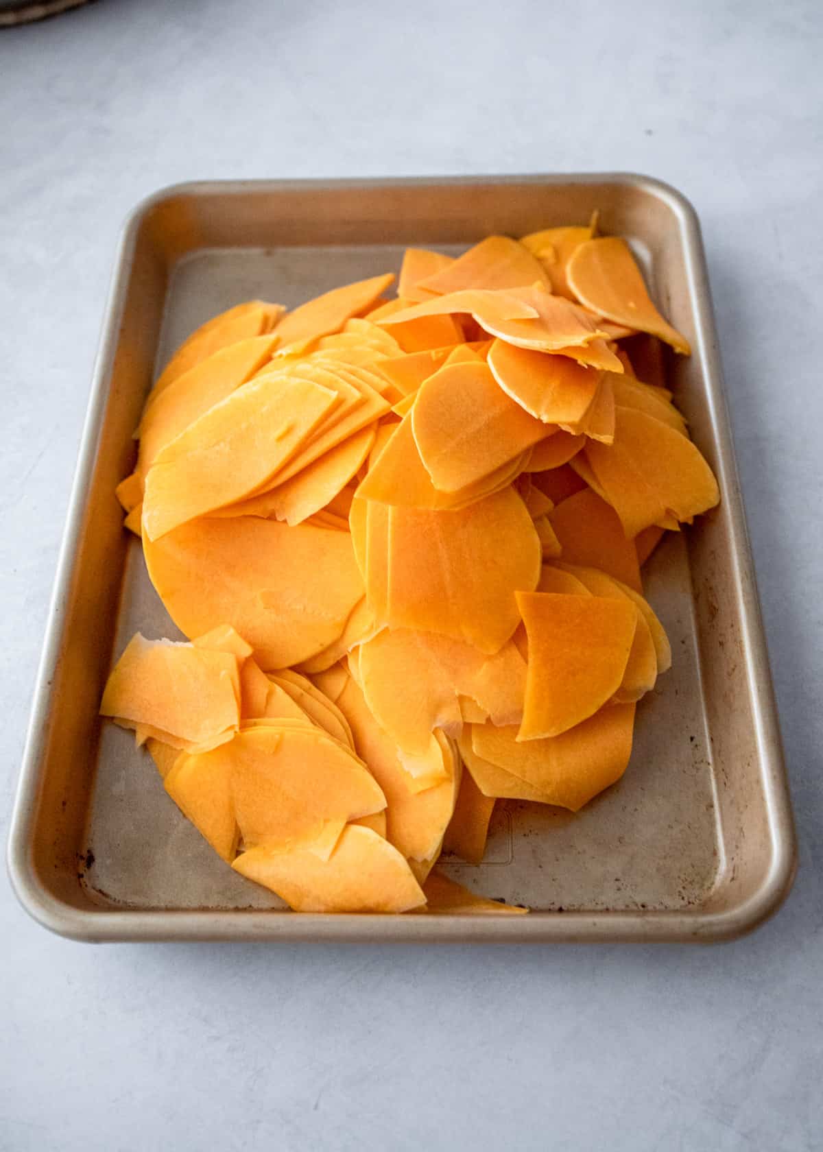 slices of butternut squash on a sheet pan