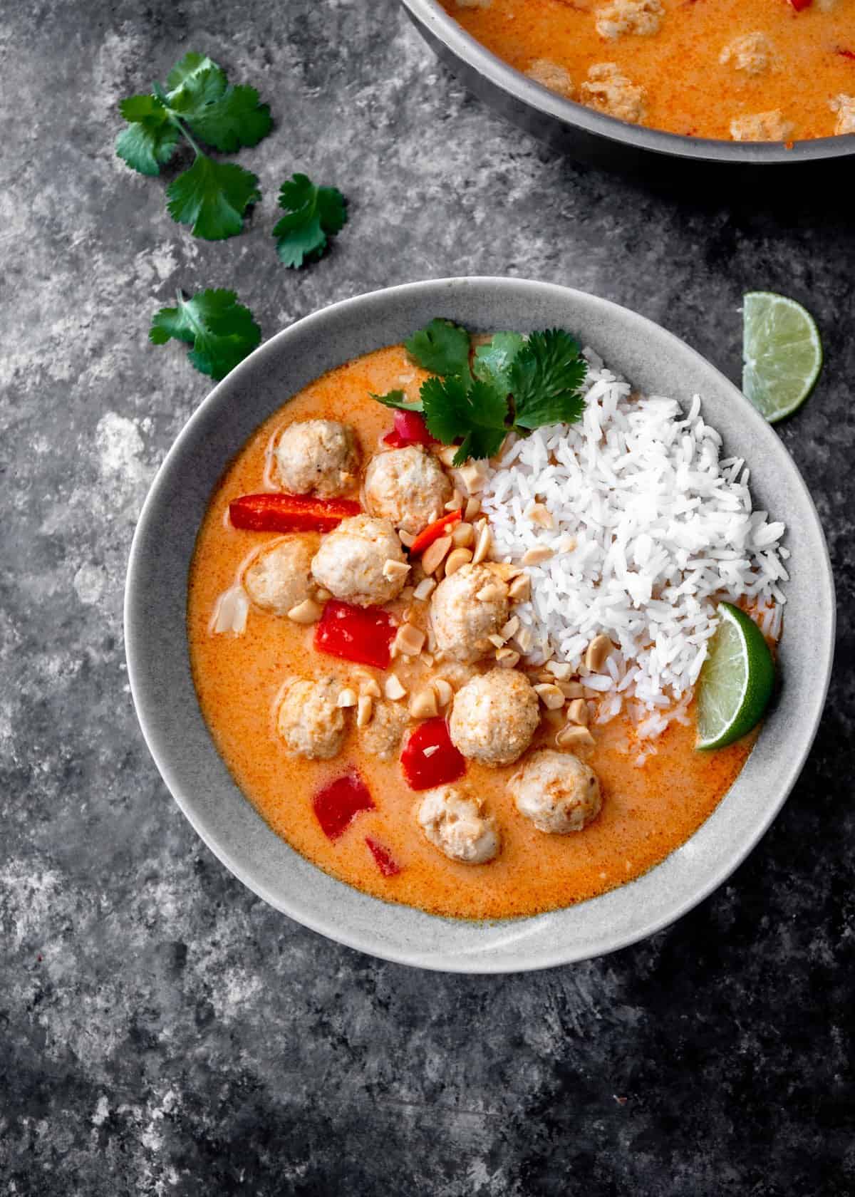 overhead image of rice and meatballs in curry in a white bowl