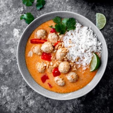thai coconut curry with chicken meatballs in a grey bowl