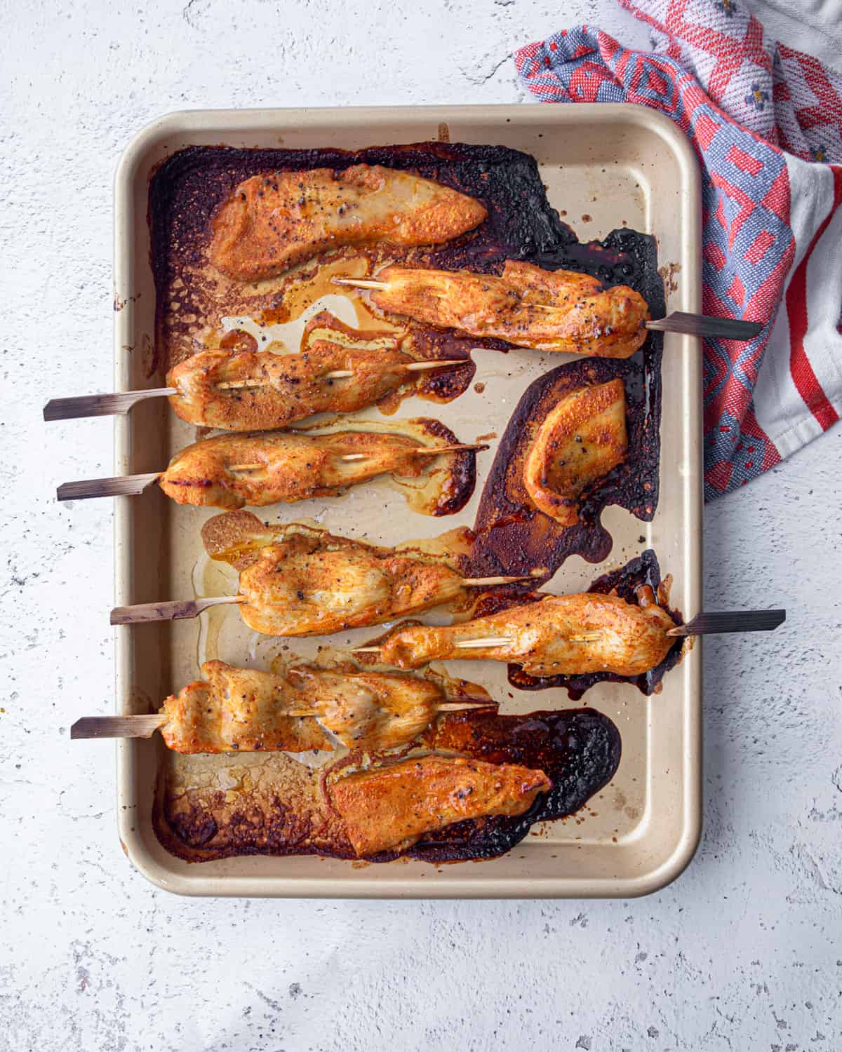 chicken skewers on a sheet pan