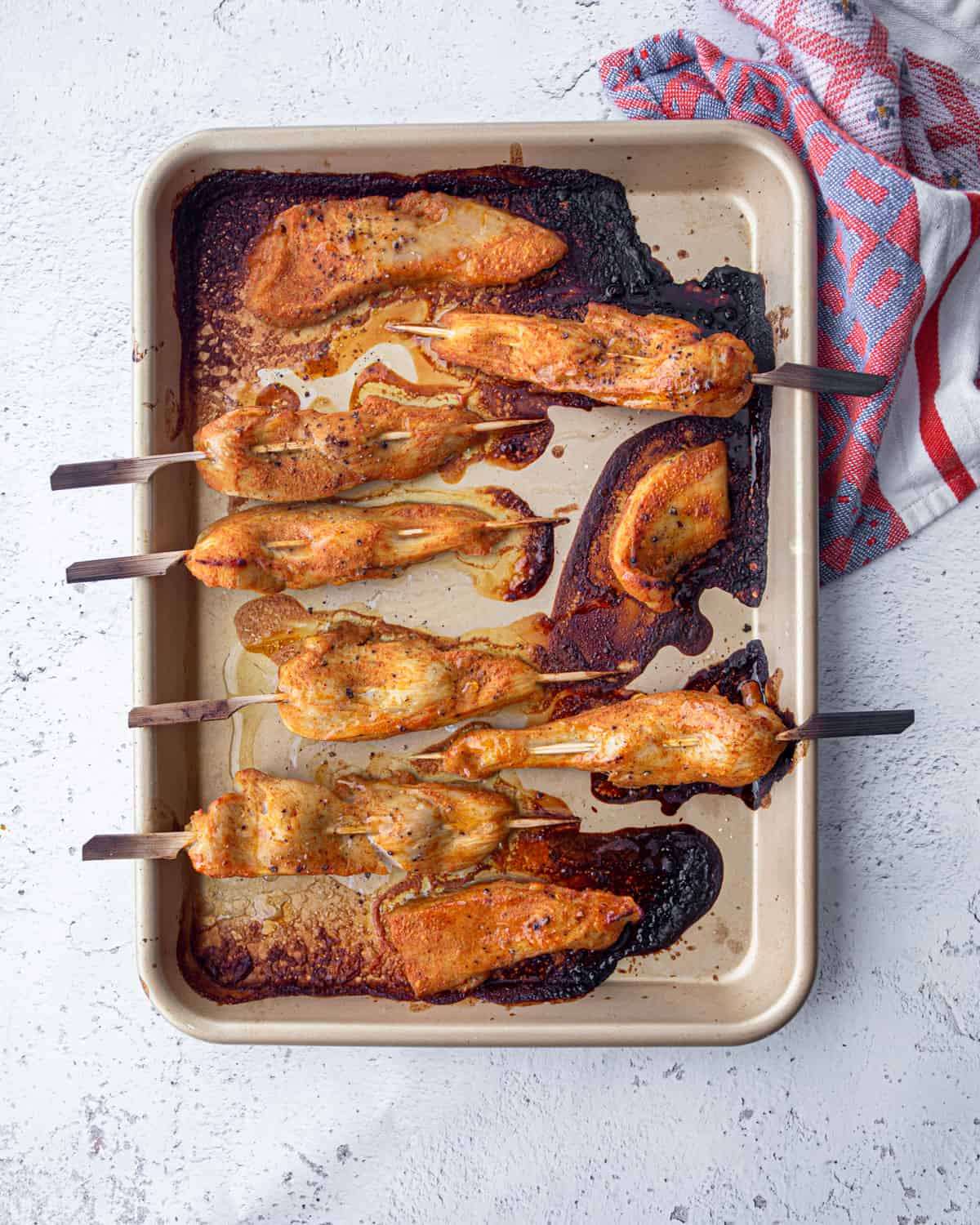 overhead image of chicken skewers on a sheet pan