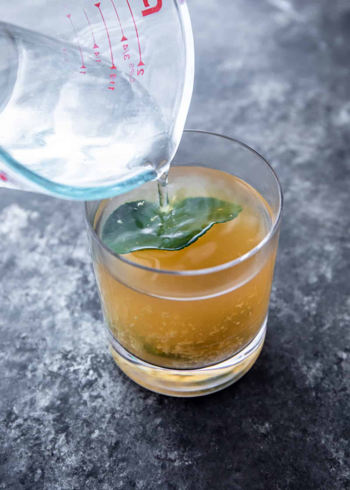 adding simple syrup to cocktail