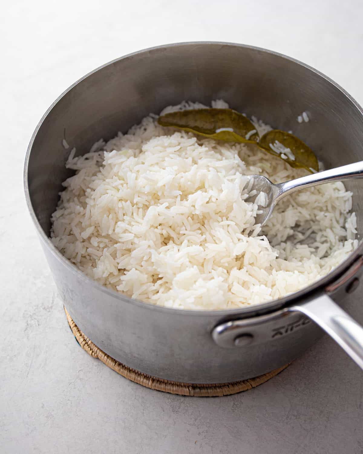fluffing cooked rice in a saucepan