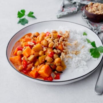 sweet potato curry over rice in a white bowl