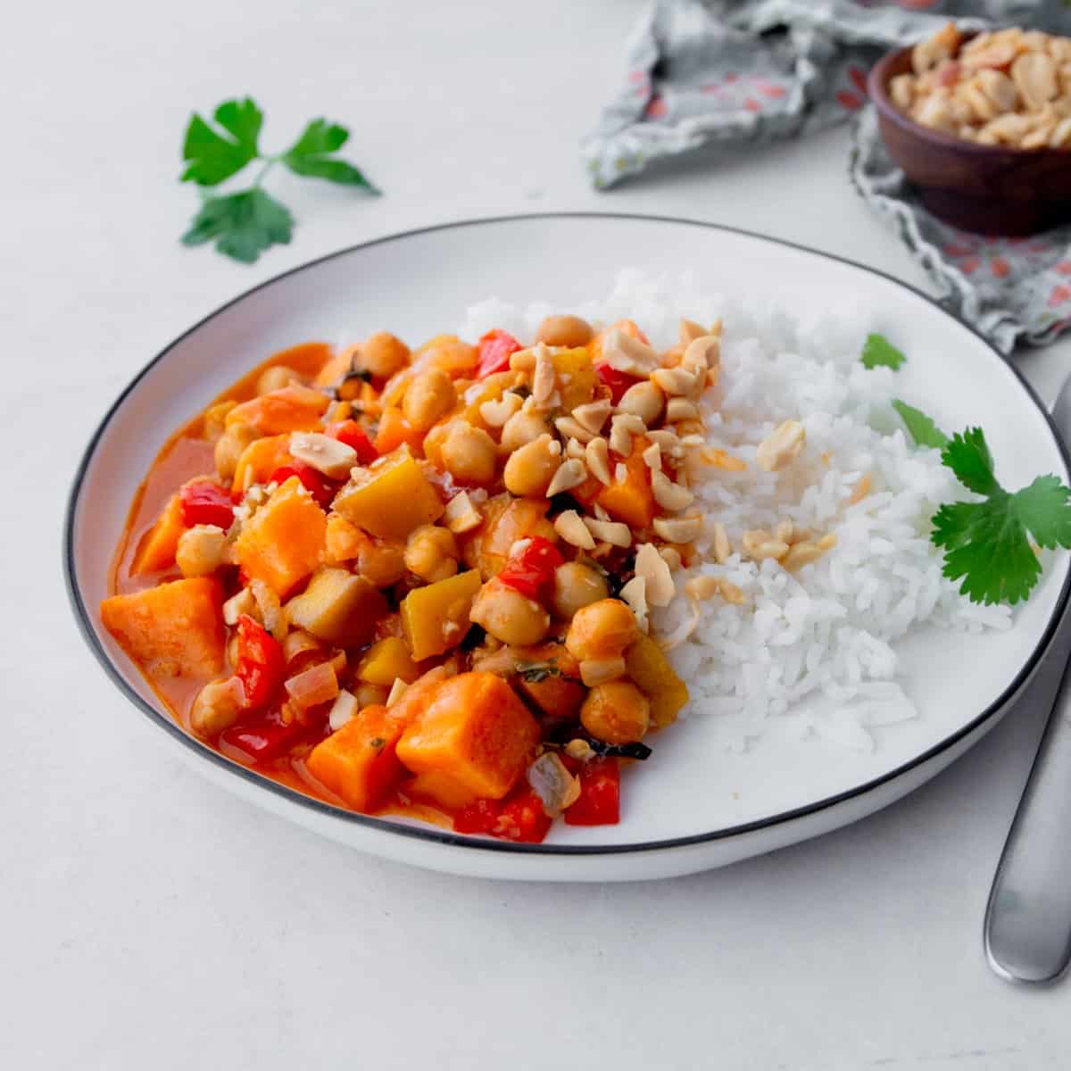 sweet potato curry over rice in a white bowl