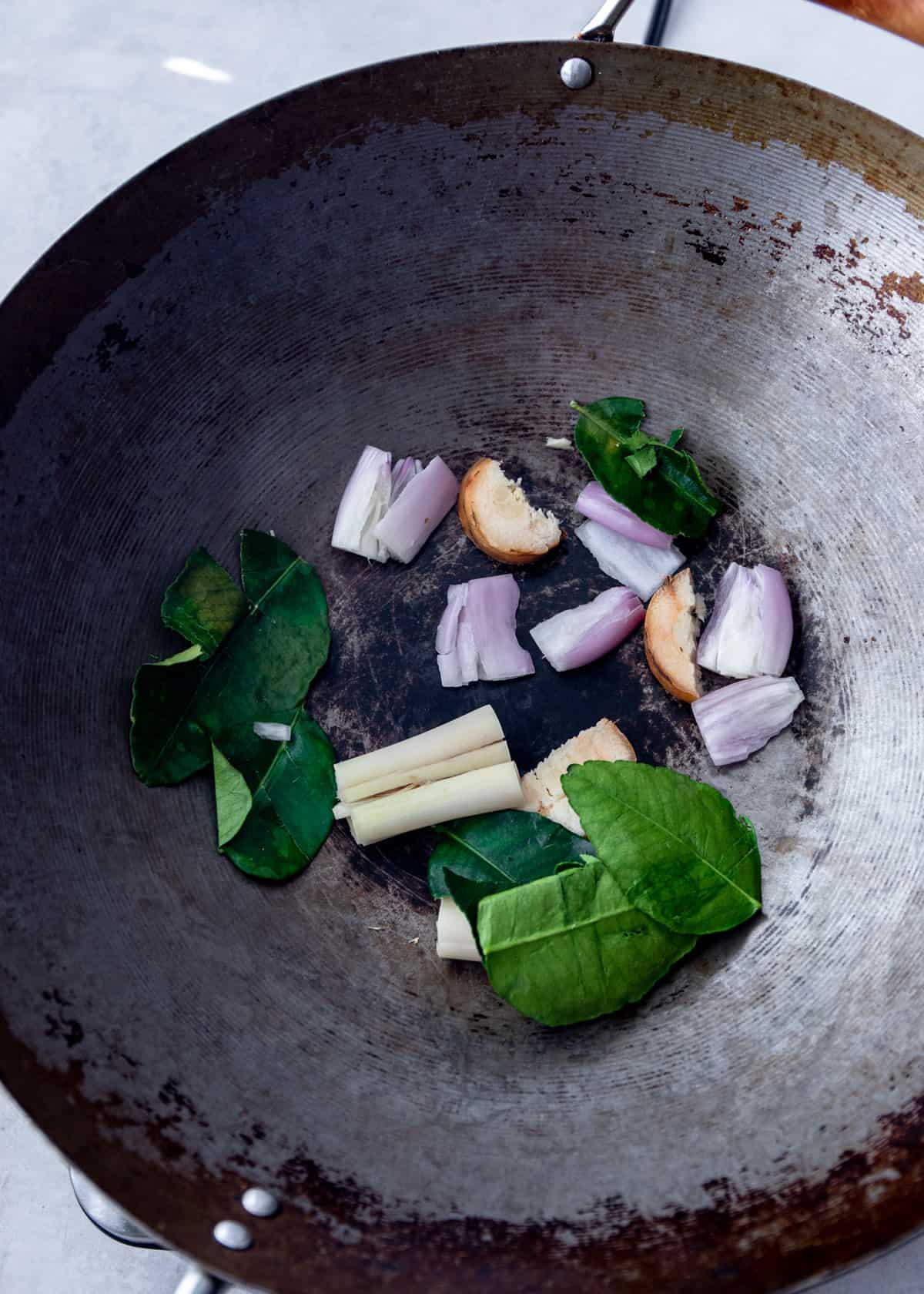 raw herbs in a wok 