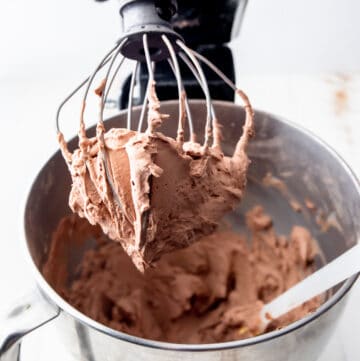 chocolate frosting on a whisk in a mixer