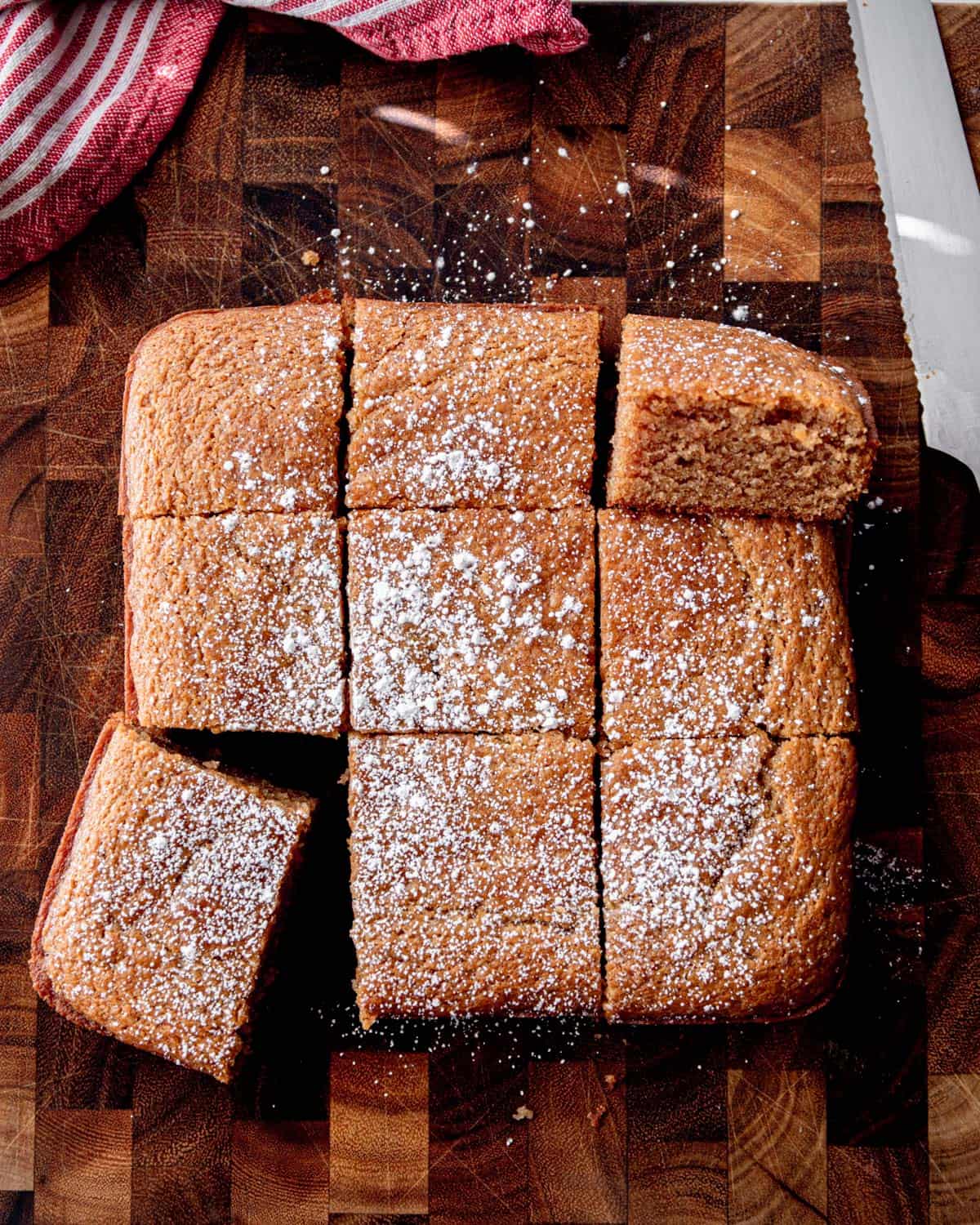 overhead image of peanut butter snack cake cut into slices on a wooden cutting board