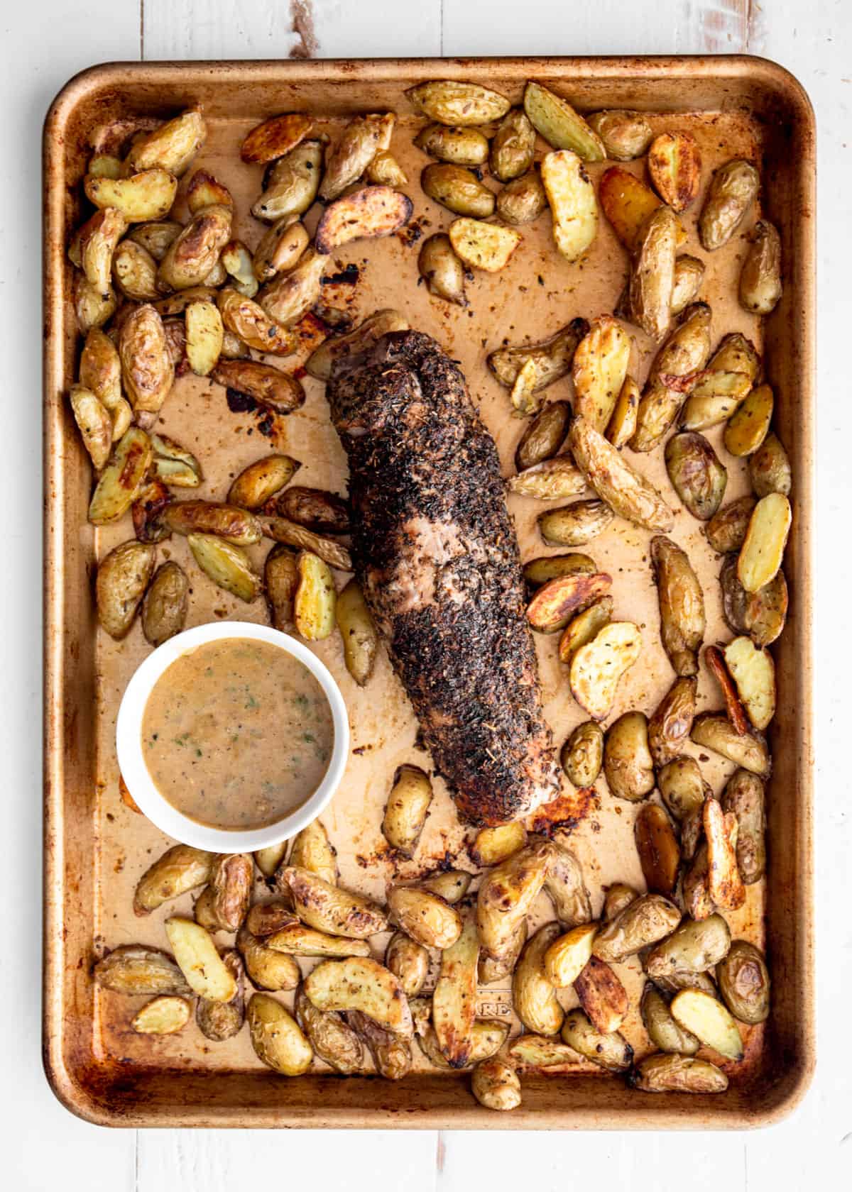 overhead image of pork and potatoes on a sheet pan