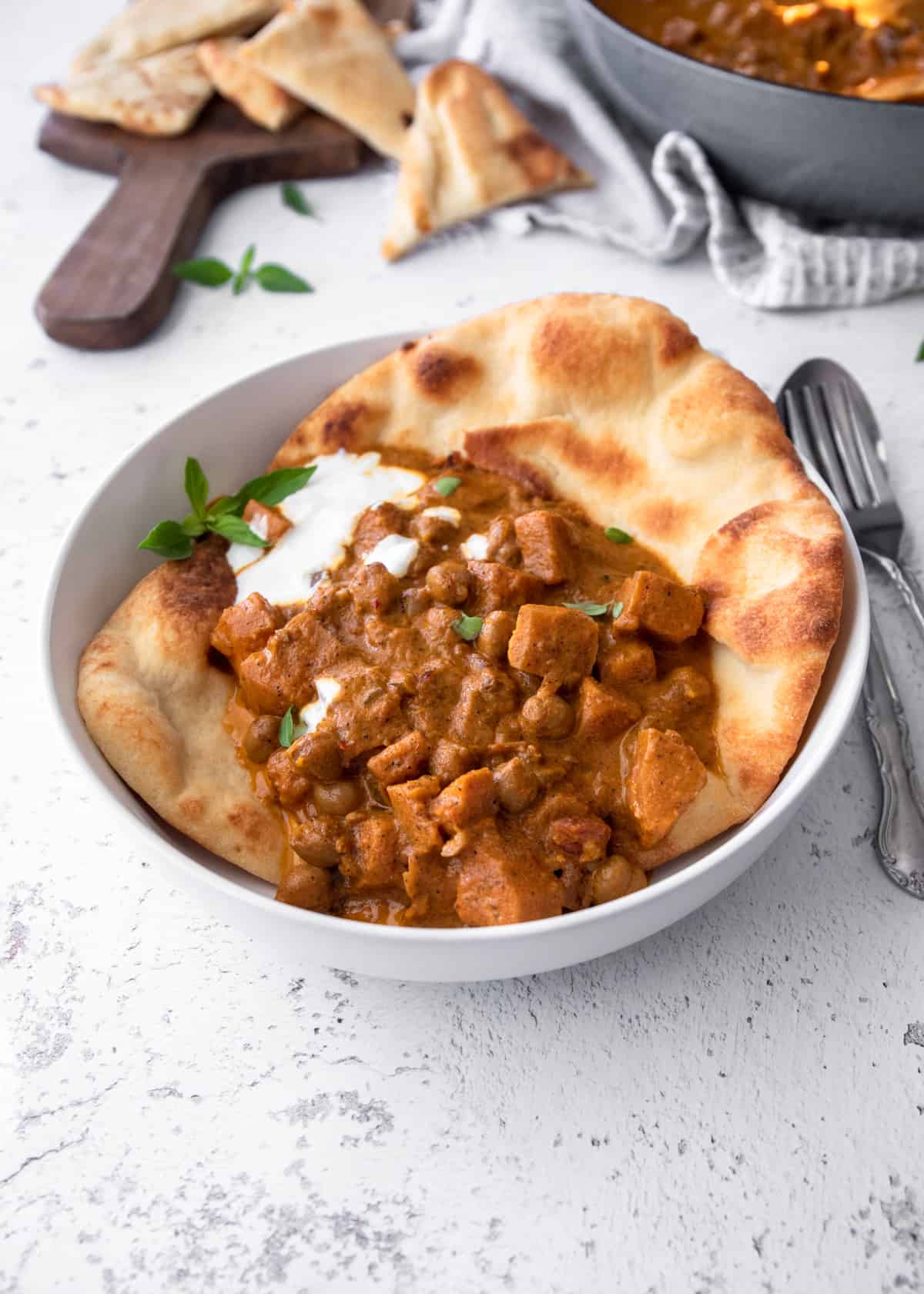 vegetarian masala and naan in a white bowl