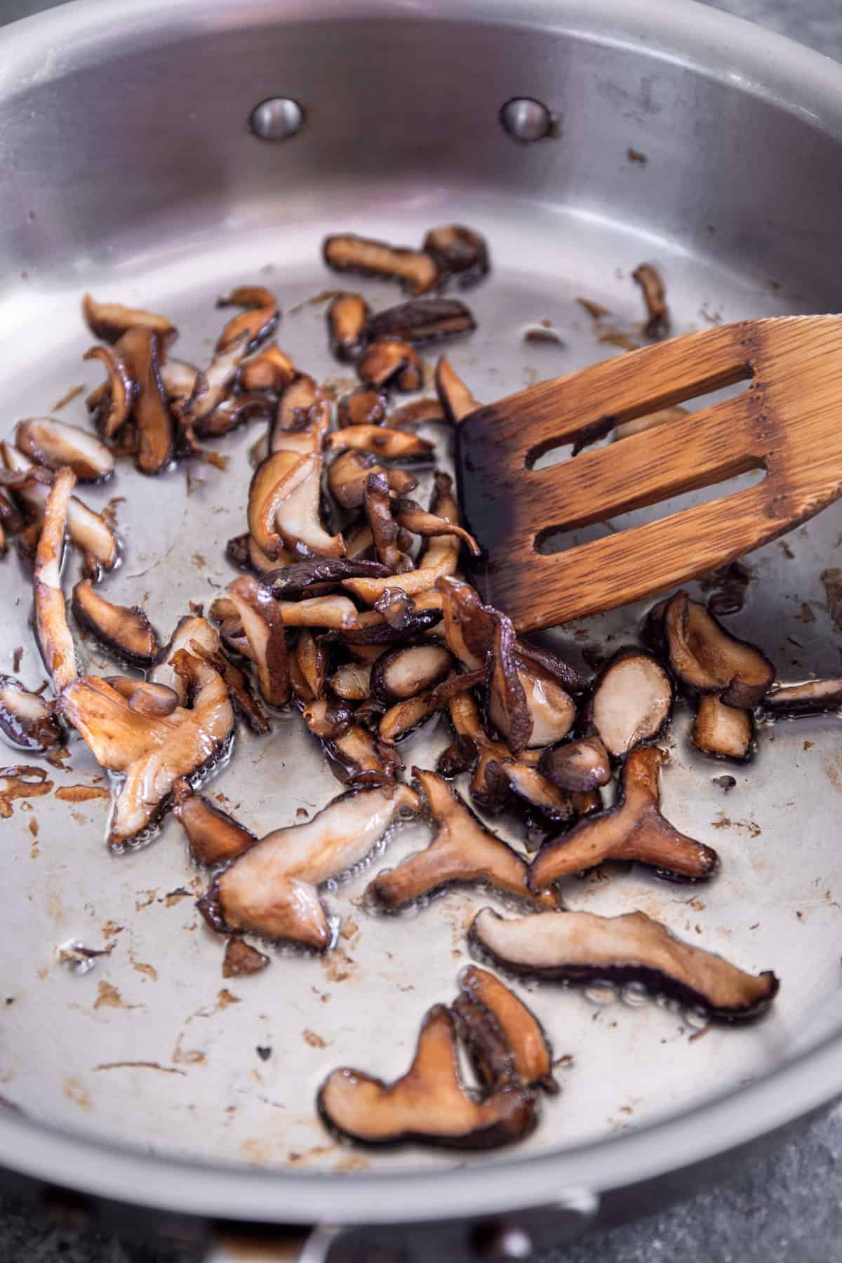 sauteeing mushrooms in a skillet