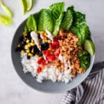 chicken, lettuce, rice and black beans in a gray bowl