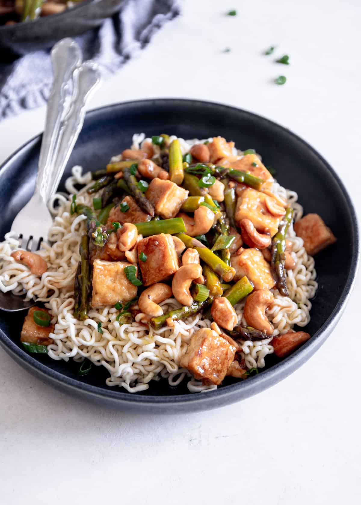 tofu stir fry in a black bowl