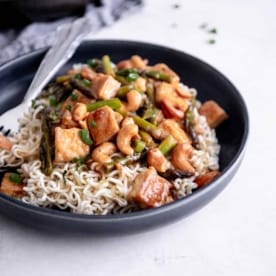 stir fry in a black bowl