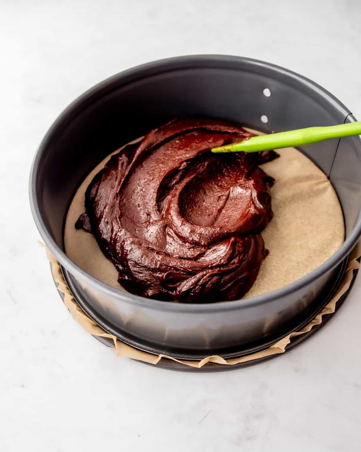 spreading chocolate cake batter in a springform pan