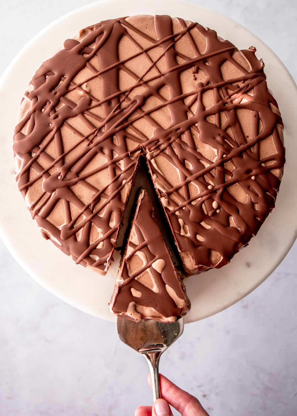 cutting a slice of brownie ice cream cake