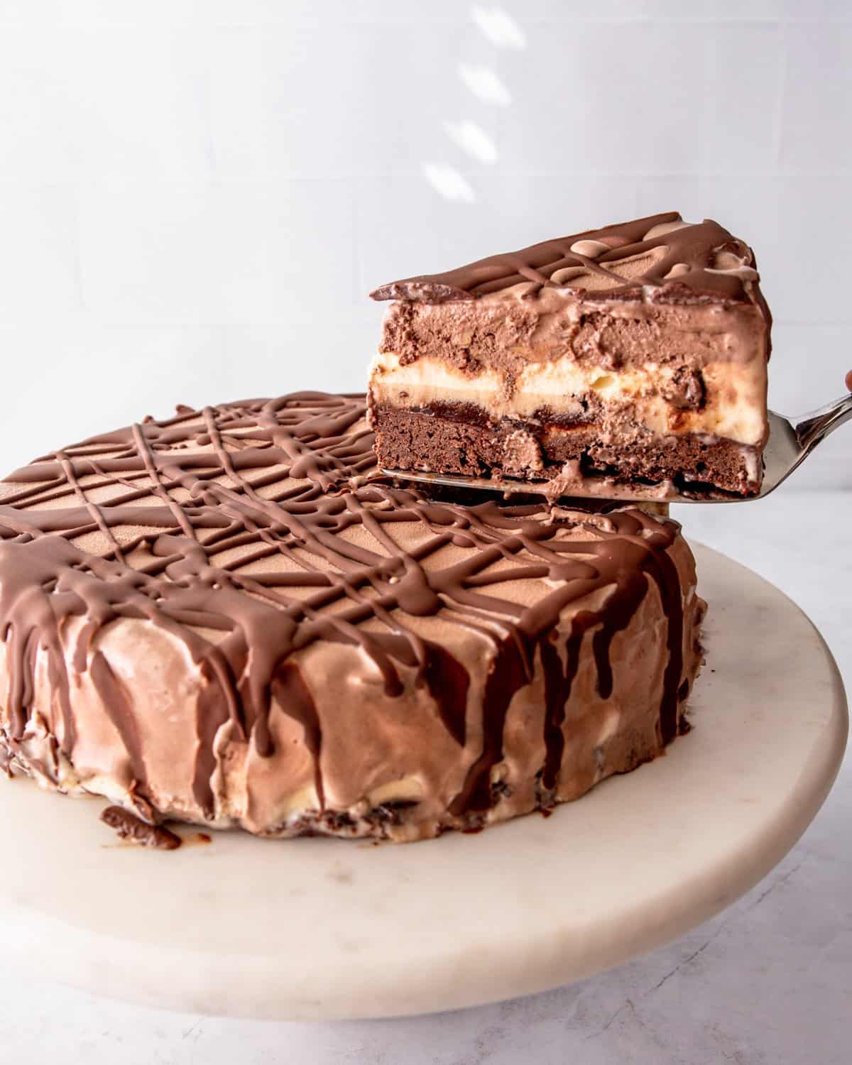 cutting a slice of chocolate ice cream cake