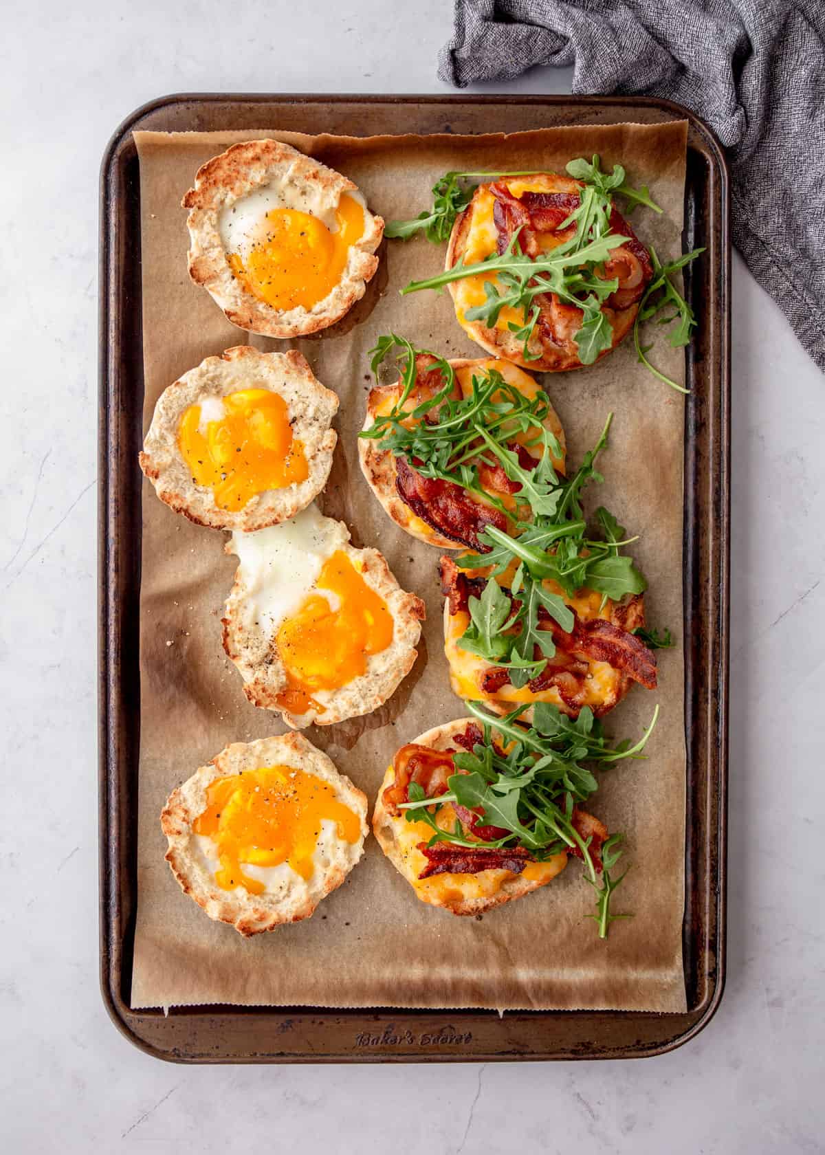 open face breakfast sandwiches on a sheet pan