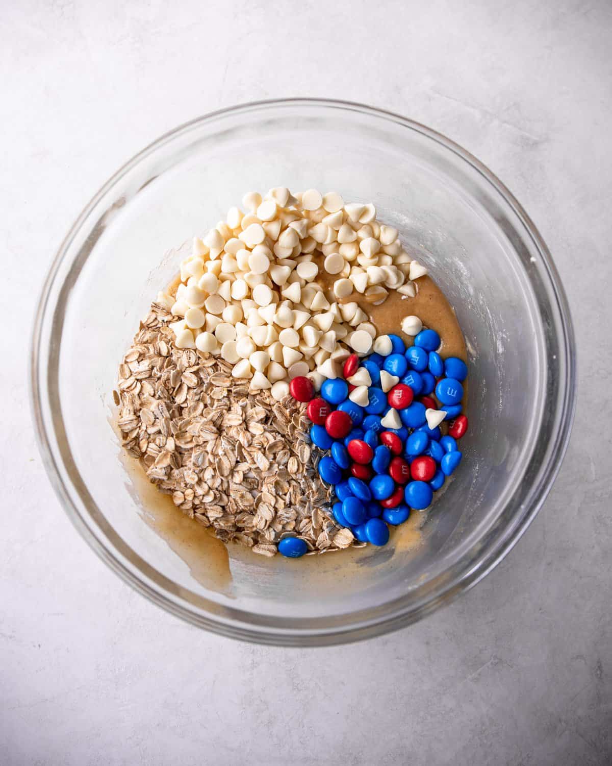 overhead shot of ingredients for cookie bars in a clear bowl
