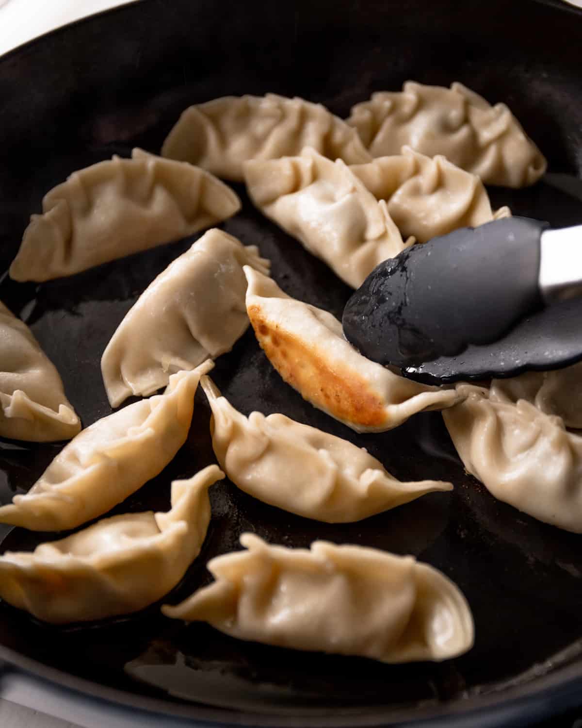cooking potstickers in a skillet