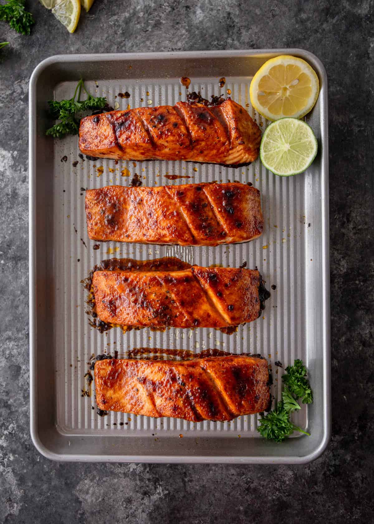 overhead image of broiled salmon on a sheet pan